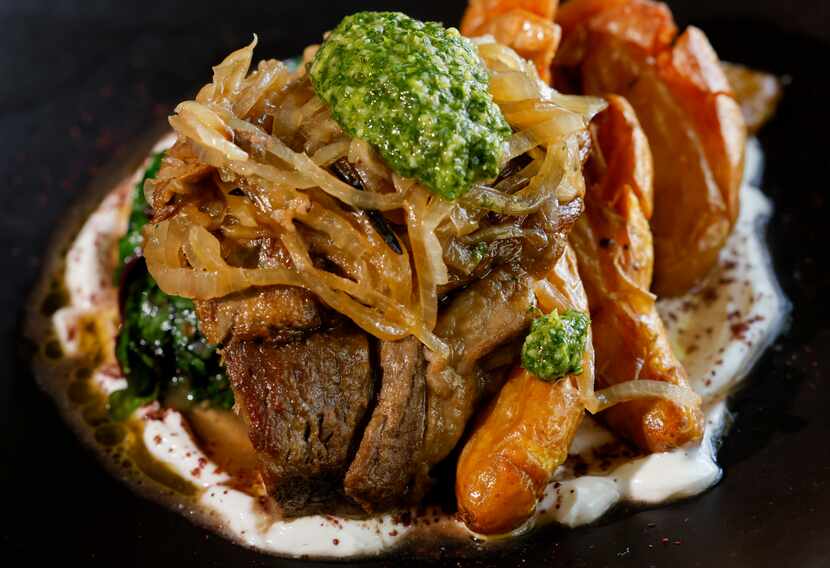 The braised lamb shoulder at Isla & Co. has layers: creamy labneh underneath, spicy zhoug on...