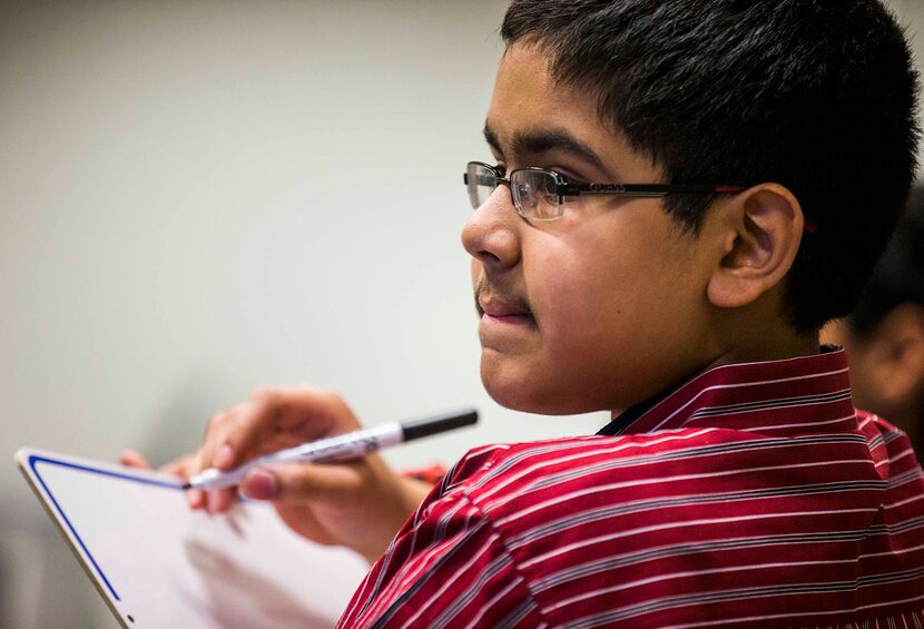  Dhruv Nistala, seventh grader from Noel Grisham Middle School in Austin, writes his answer...