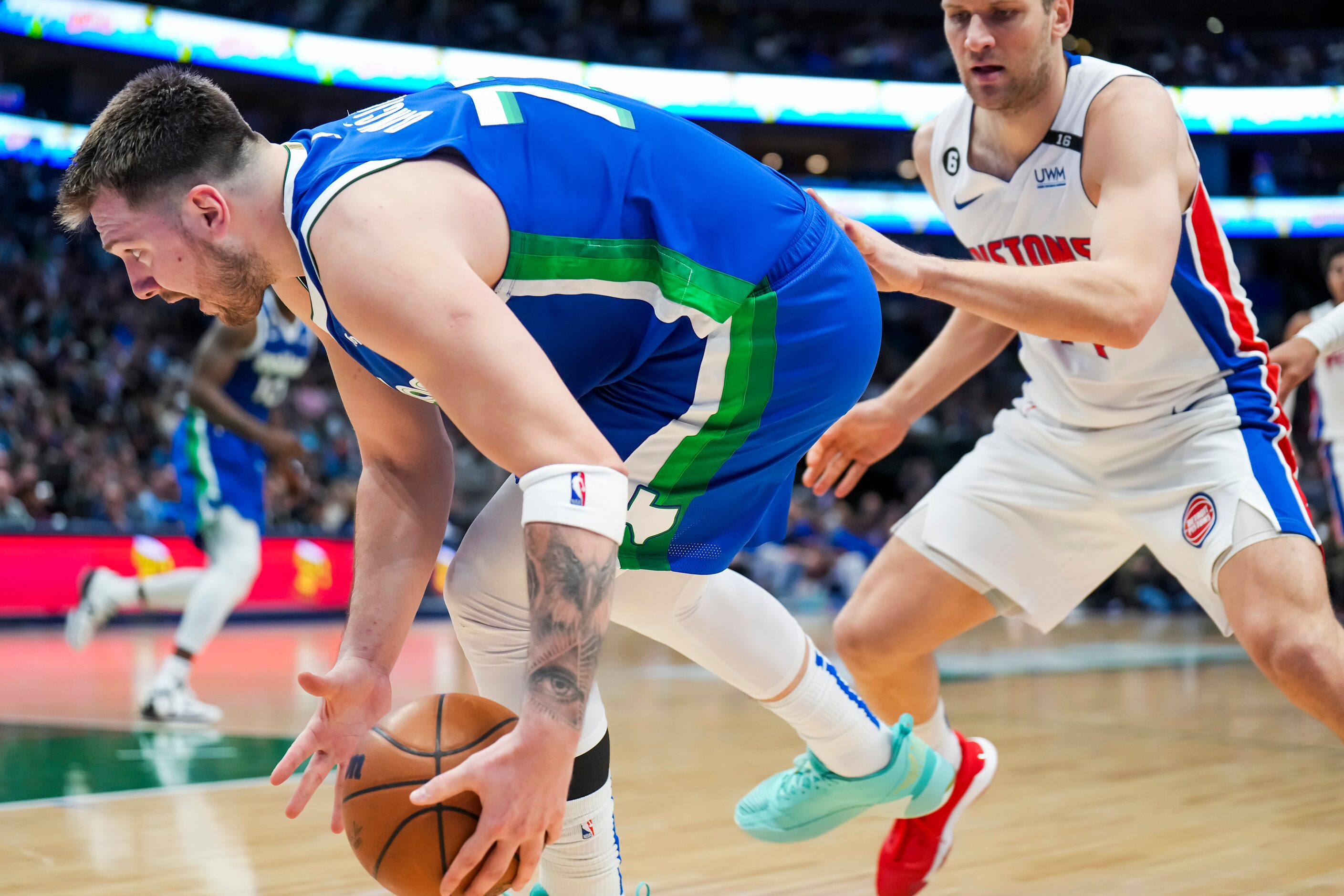 Dallas Mavericks guard Luka Doncic (77) steals the ball from Detroit Pistons forward Bojan...