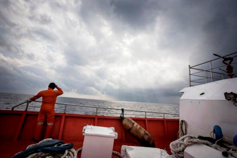
Indonesian search and rescue personnel watched over high seas during a search operation for...