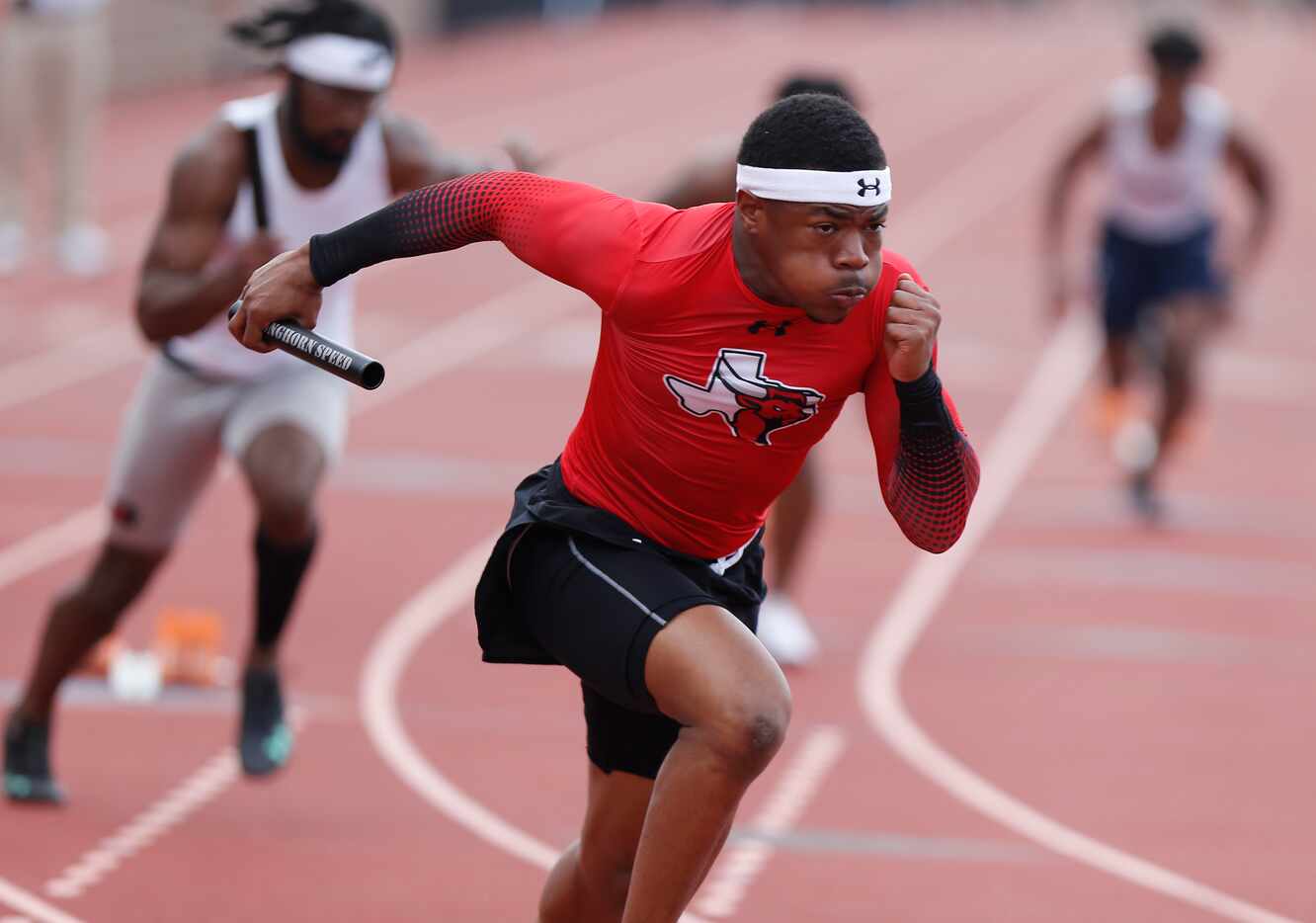 Kaleb Green, 17, begins the first leg of the boys 4 x100 for Lancaster High School during...