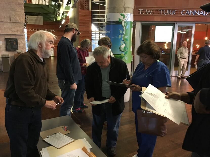 Cedar Hill resident Wes Pool hands out information before a City Council meeting to discuss...