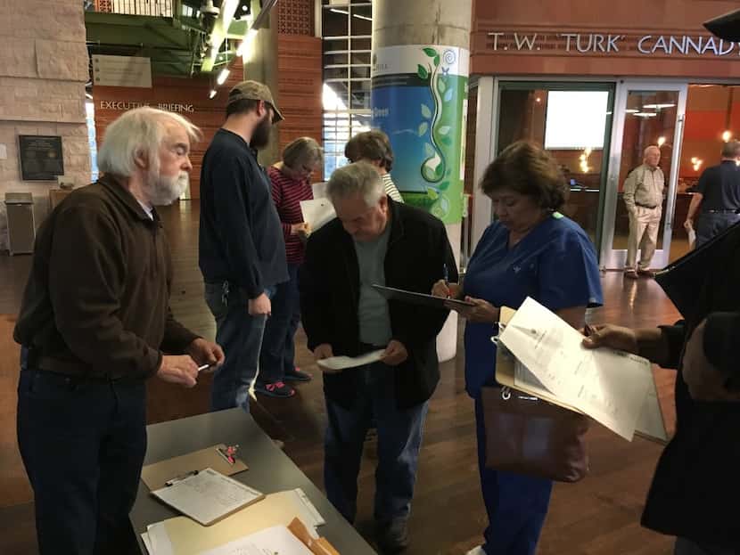 Cedar Hill resident Wes Pool hands out information before a City Council meeting to discuss...