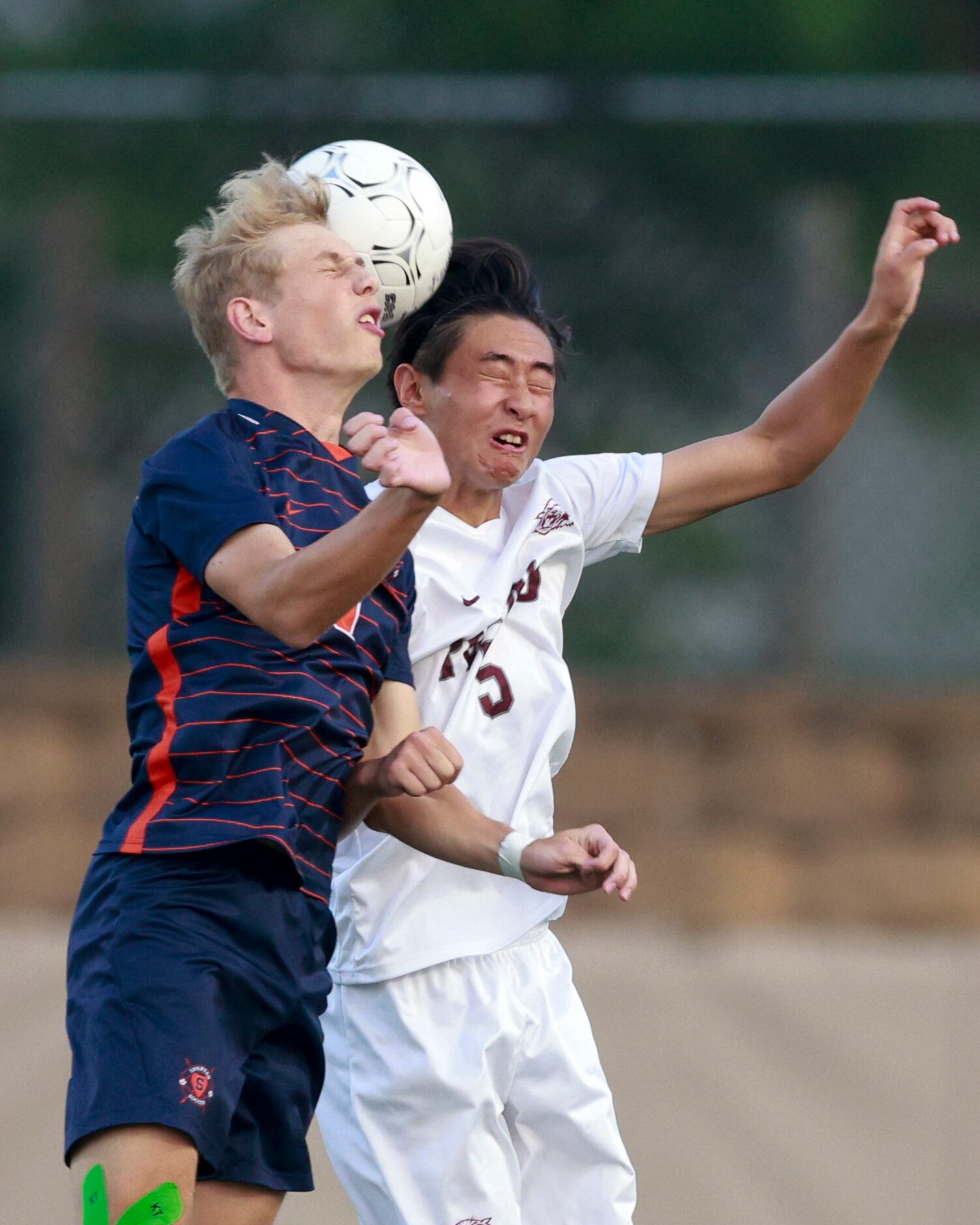 Plano defender Koen Kok (5) and Katy Seven Lakes forward Hunter Merritt (9) jump to head the...