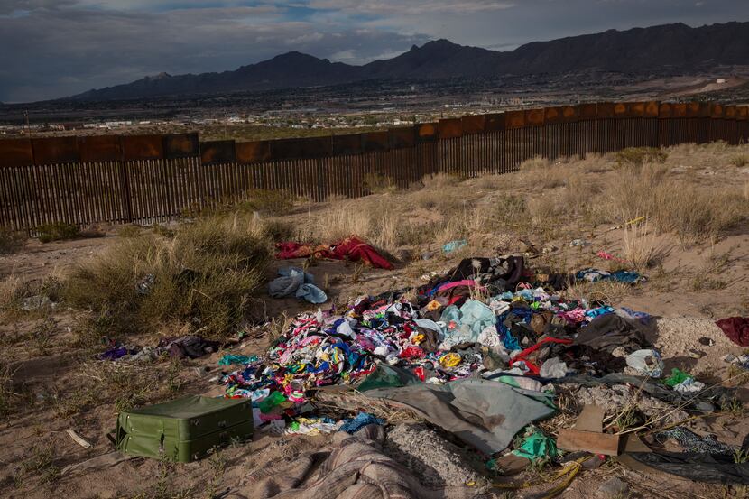 Clothes lay abandoned near a newly erected fence at the U.S.-Mexico border in the Anapra...