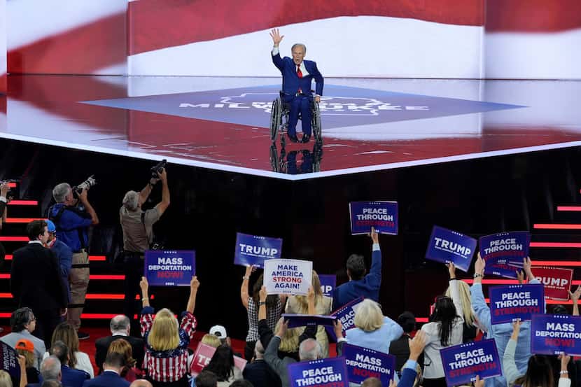 Gov. Greg Abbott, R-Texas, gestures to supporters during the Republican National Convention...
