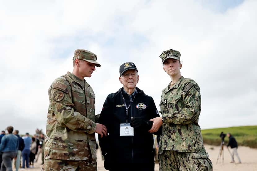 U.S. soldiers assisted American World War II veteran Fred Taylor during a ceremony at Omaha...