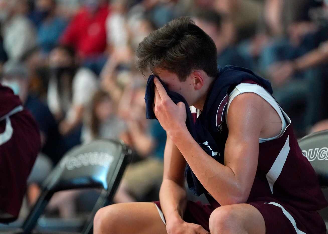 Irving Faustina’s Ben Nelson (33) covers his face after coming off the court late in the...