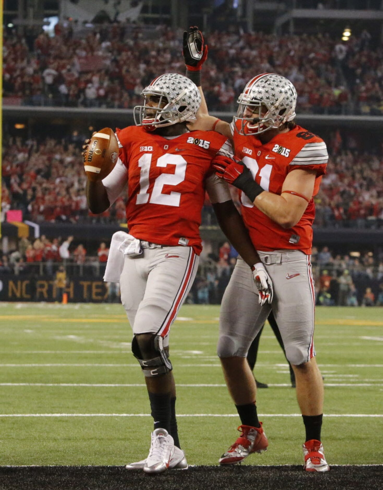 Ohio State Buckeyes quarterback Cardale Jones (12) is congratulated by Ohio State Buckeyes...