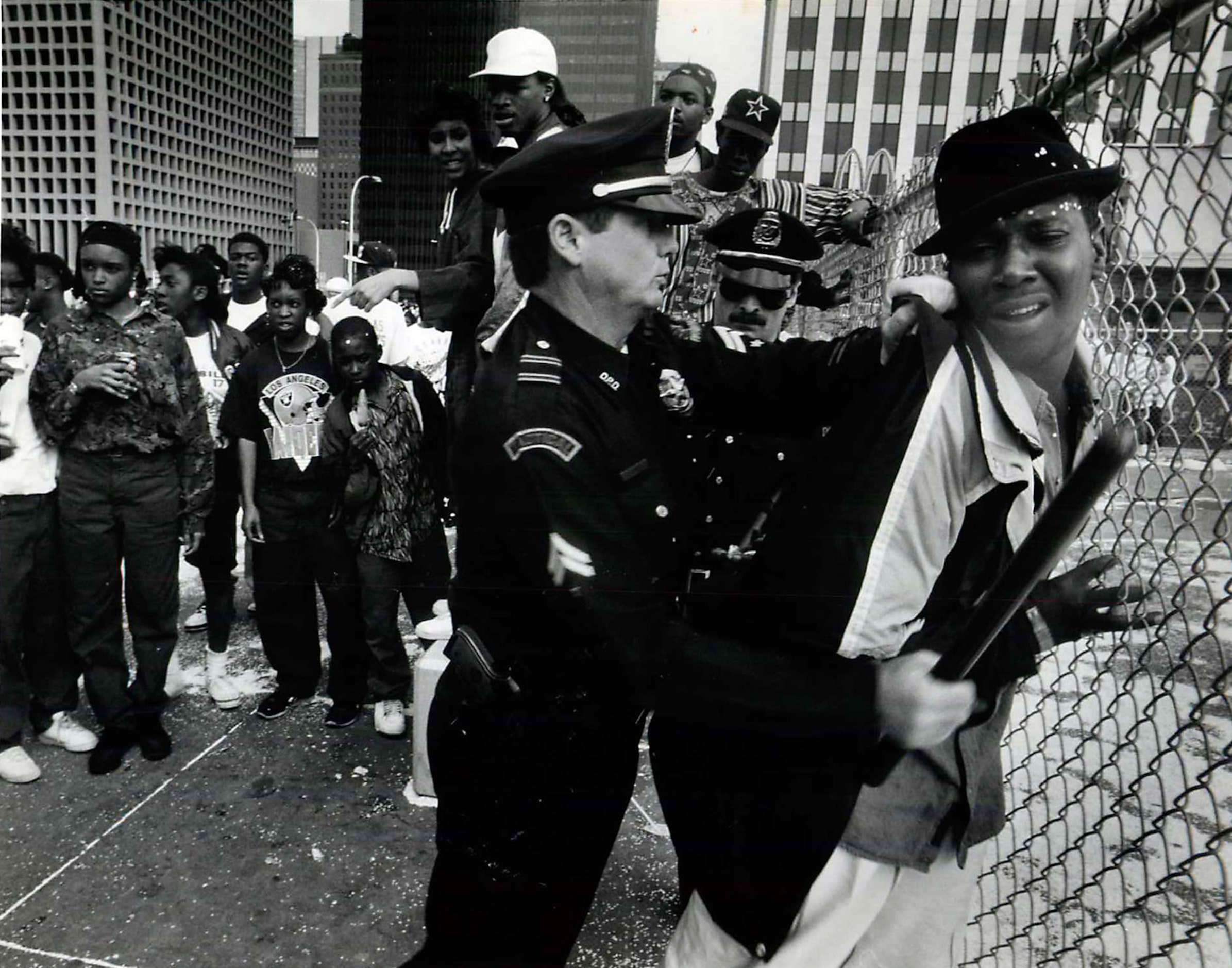 A man is restrained by Dallas police during post Super Bowl victory parade violence in...