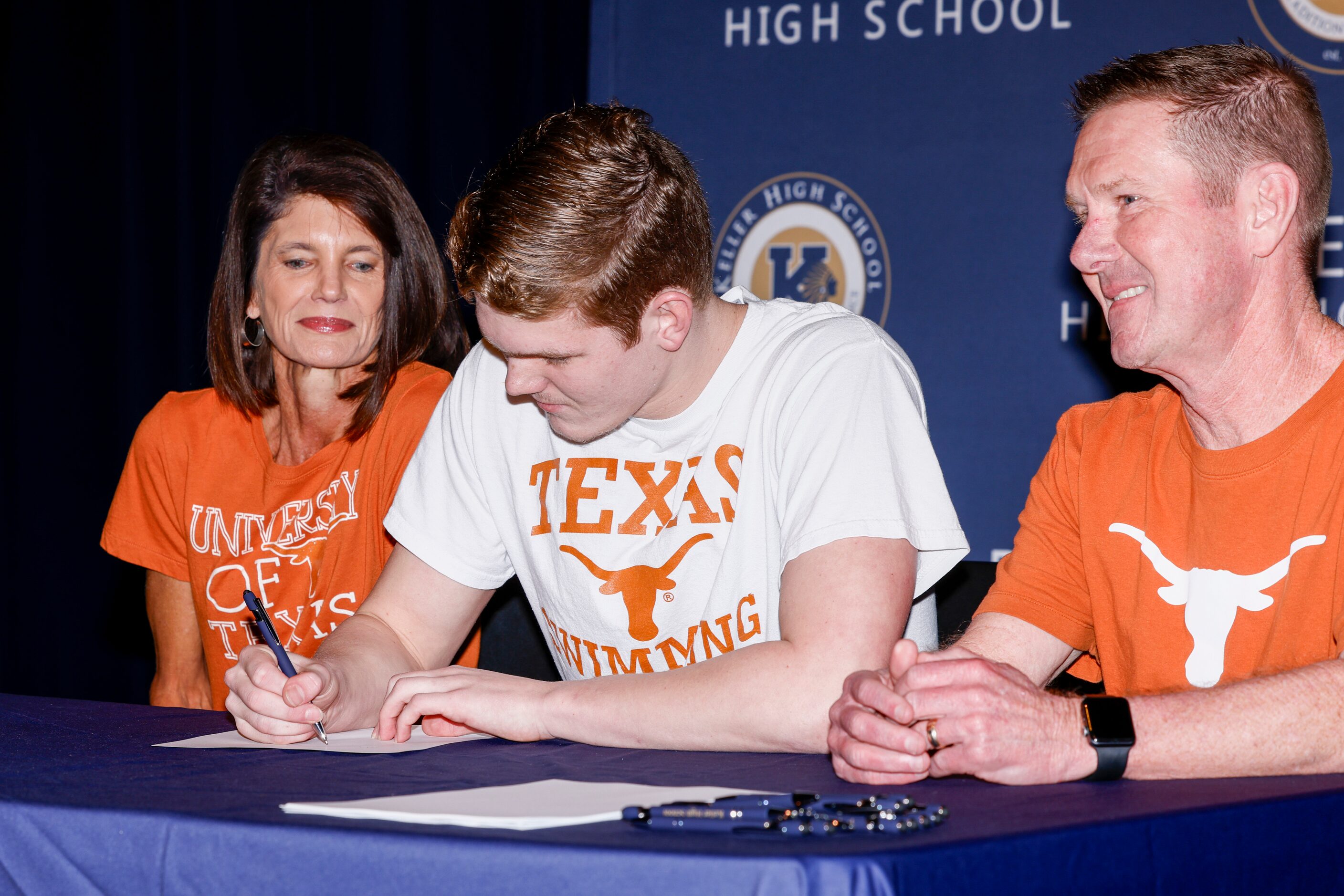 Keller swimmer Cooper Lucas signs with the University of Texas at Austin alongside his...