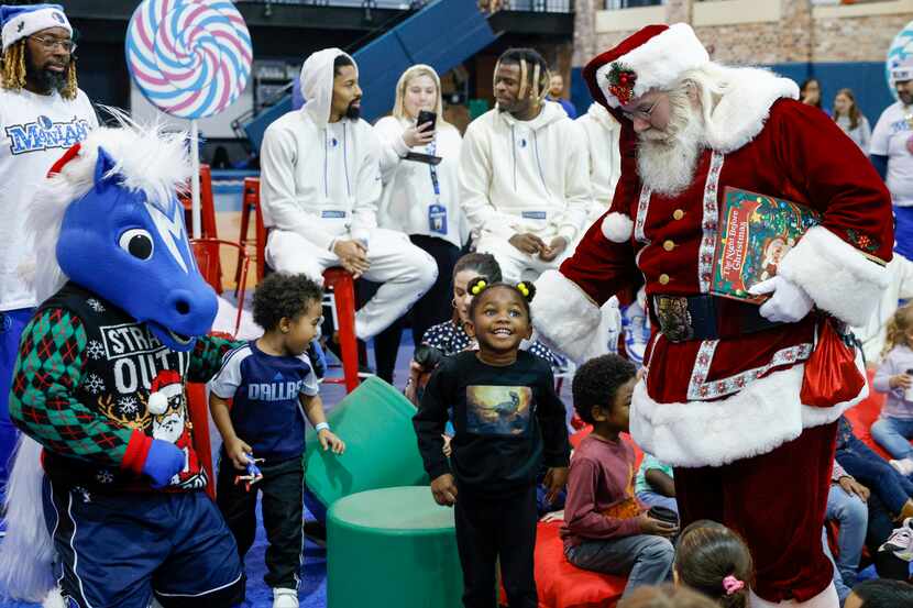 Santa Claus greet children from Vogel Alcove during the Dallas Mavericks Cookies with Santa...
