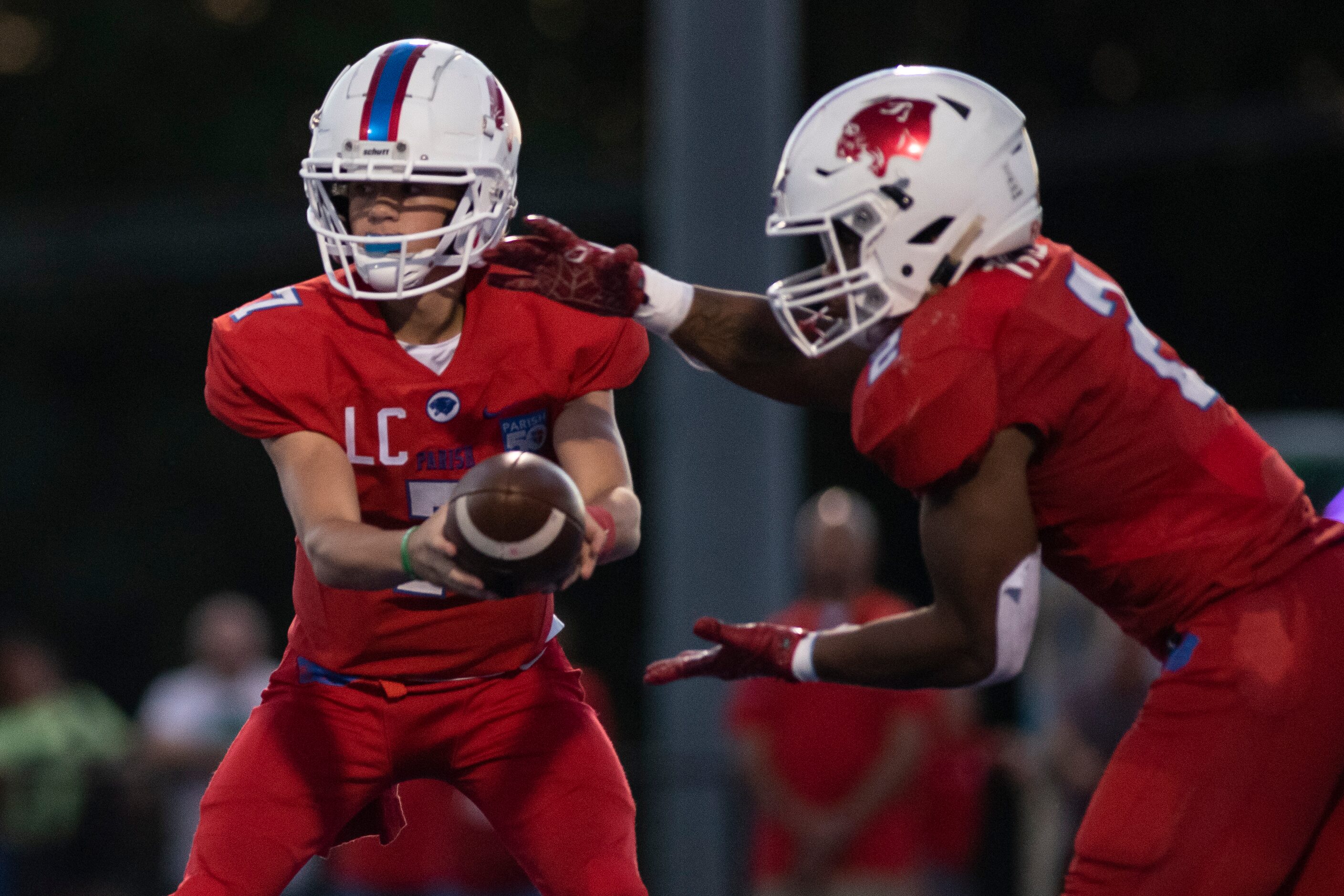 Parish Episcopal freshman Sawyer Anderson (7) hands the ball off to Parish Episcopal senior...