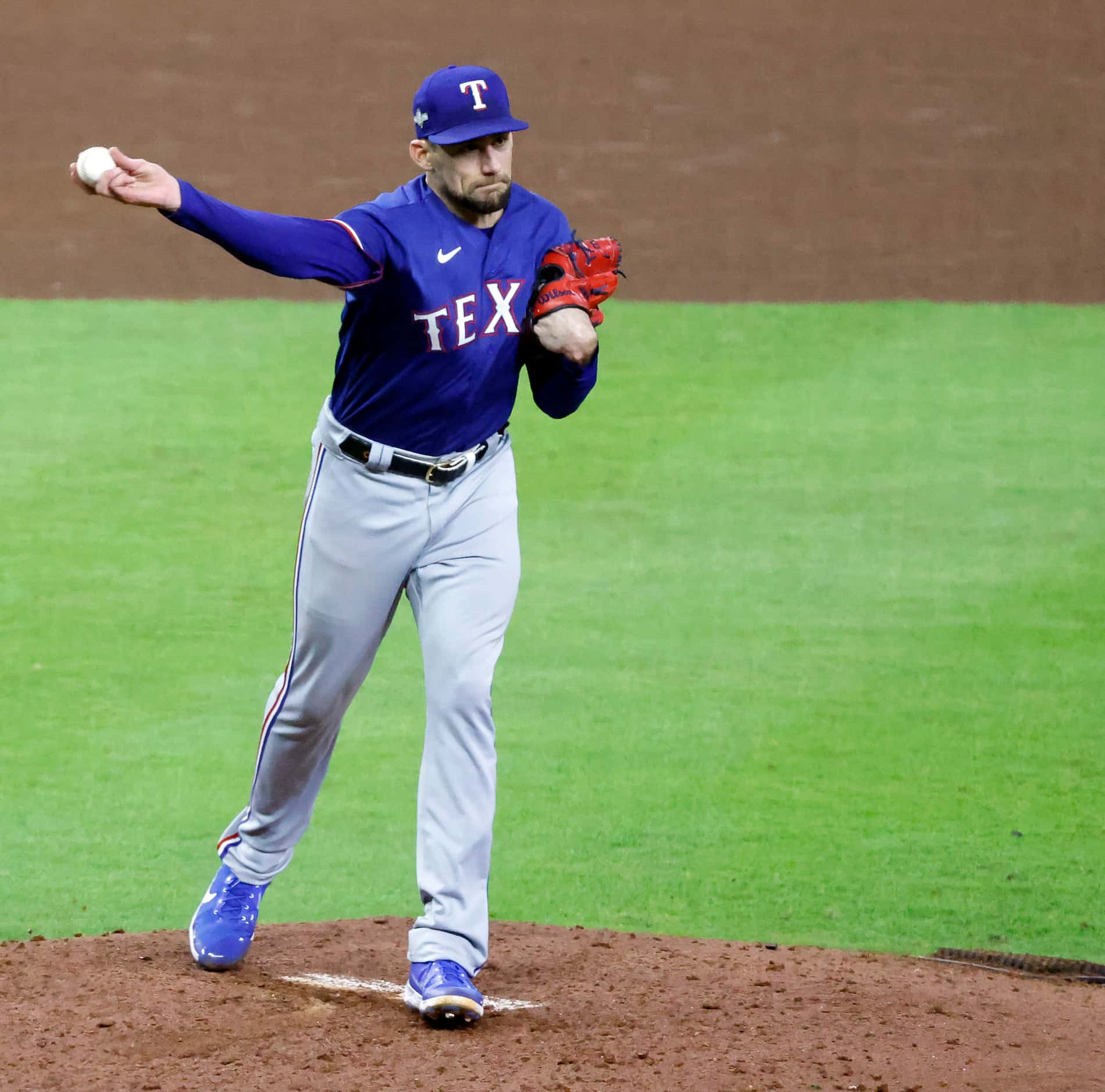 Texas Rangers starting pitcher Nathan Eovaldi (17) spins and throws to first in attempt to...