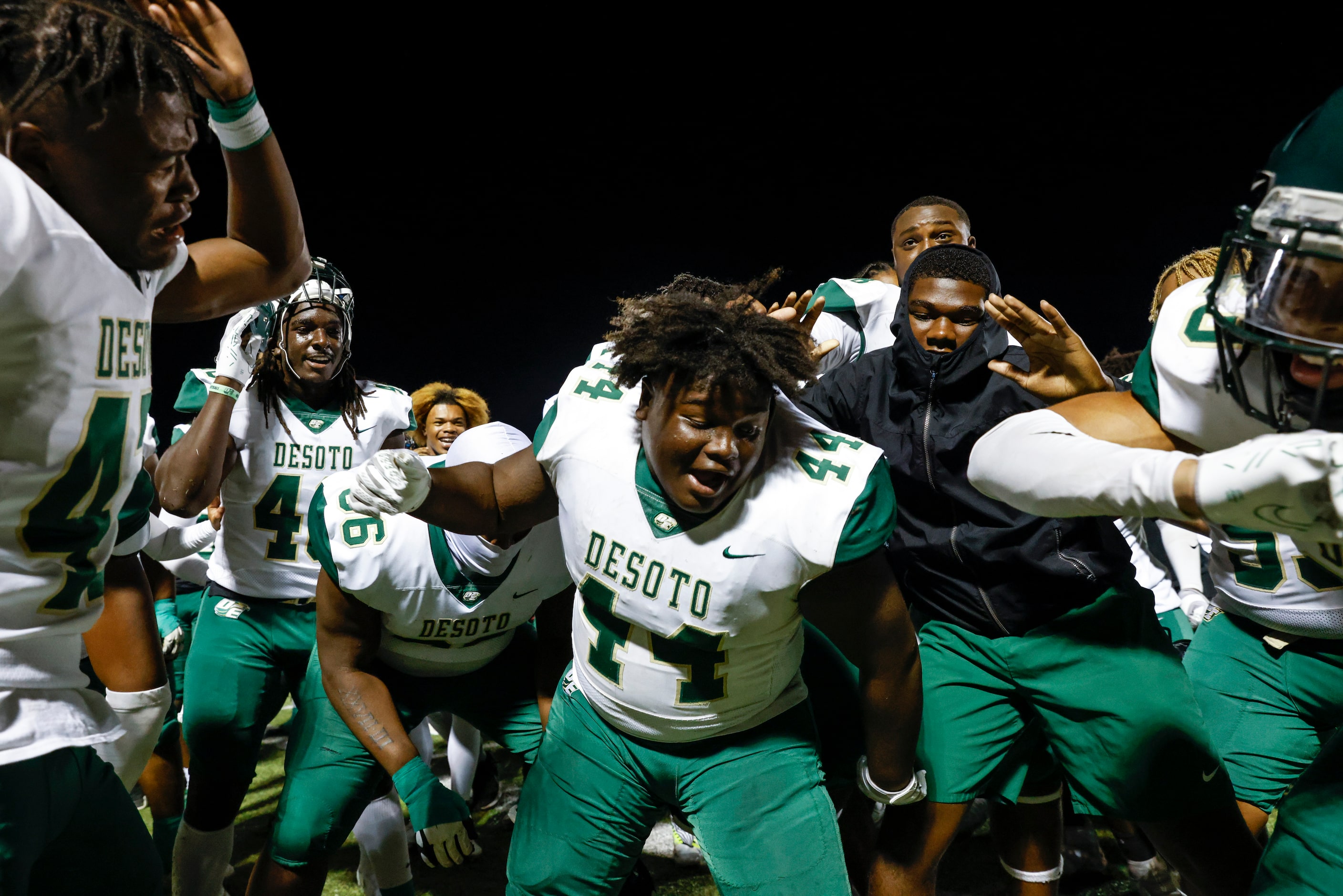 DeSoto players including Marshall Kirven (44) celebrate after winning against Lake Ridge...