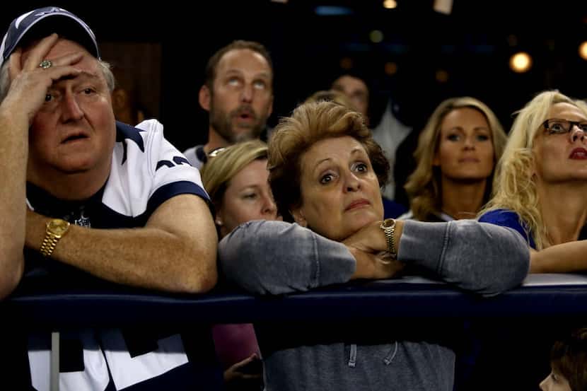 Jim Nichols, left, Connie Evans, center and Cissy Horton react as the Packers take the lead...