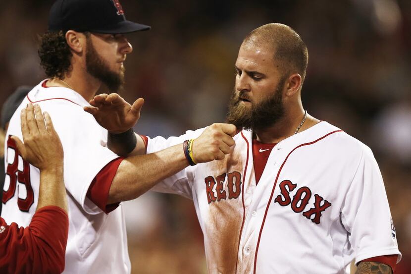 BOSTON, MA - AUGUST 31:  Mike Napoli #12 of the Boston Red Sox has his beard pulled by...
