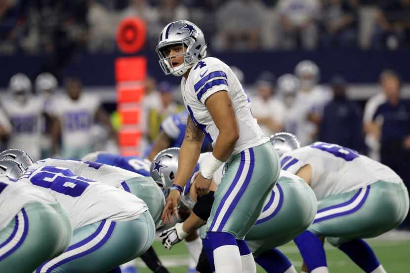 ARLINGTON, TX - DECEMBER 26: Dak Prescott #4 of the Dallas Cowboys prepares to take the snap...