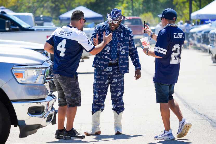 Dallas Cowboys fan Edwin Fox of Tampa, Fla., in his Cowboys suit, greeted other fans while...
