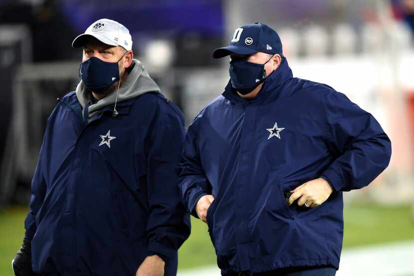 Dallas Cowboys head coach Mike McCarthy, right, leaves the field after an NFL football game...