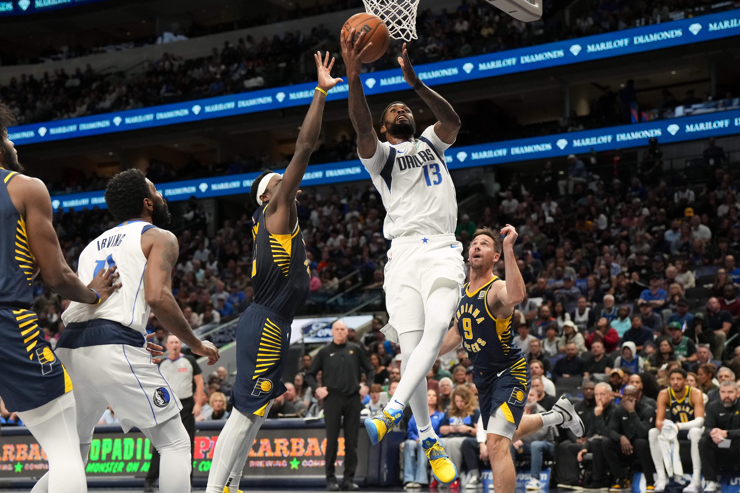 Dallas Mavericks forward Naji Marshall (13) scores past Indiana Pacers guard T.J. McConnell...