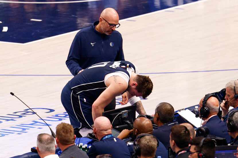 Dallas Mavericks head coach Jason Kidd checks on Dallas Mavericks guard Luka Doncic (77)...