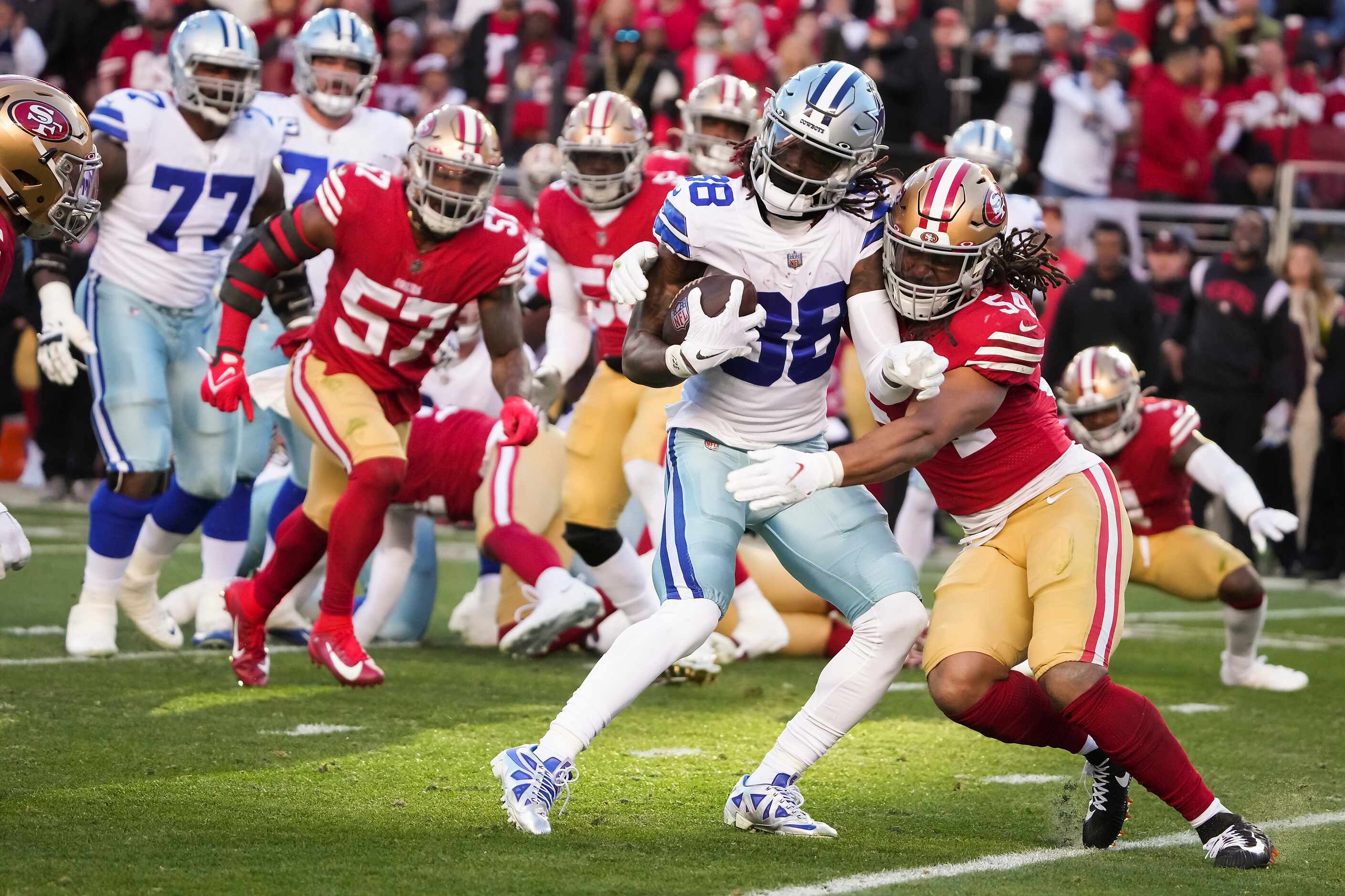 Dallas Cowboys wide receiver CeeDee Lamb (88) is brought down by San Francisco 49ers...