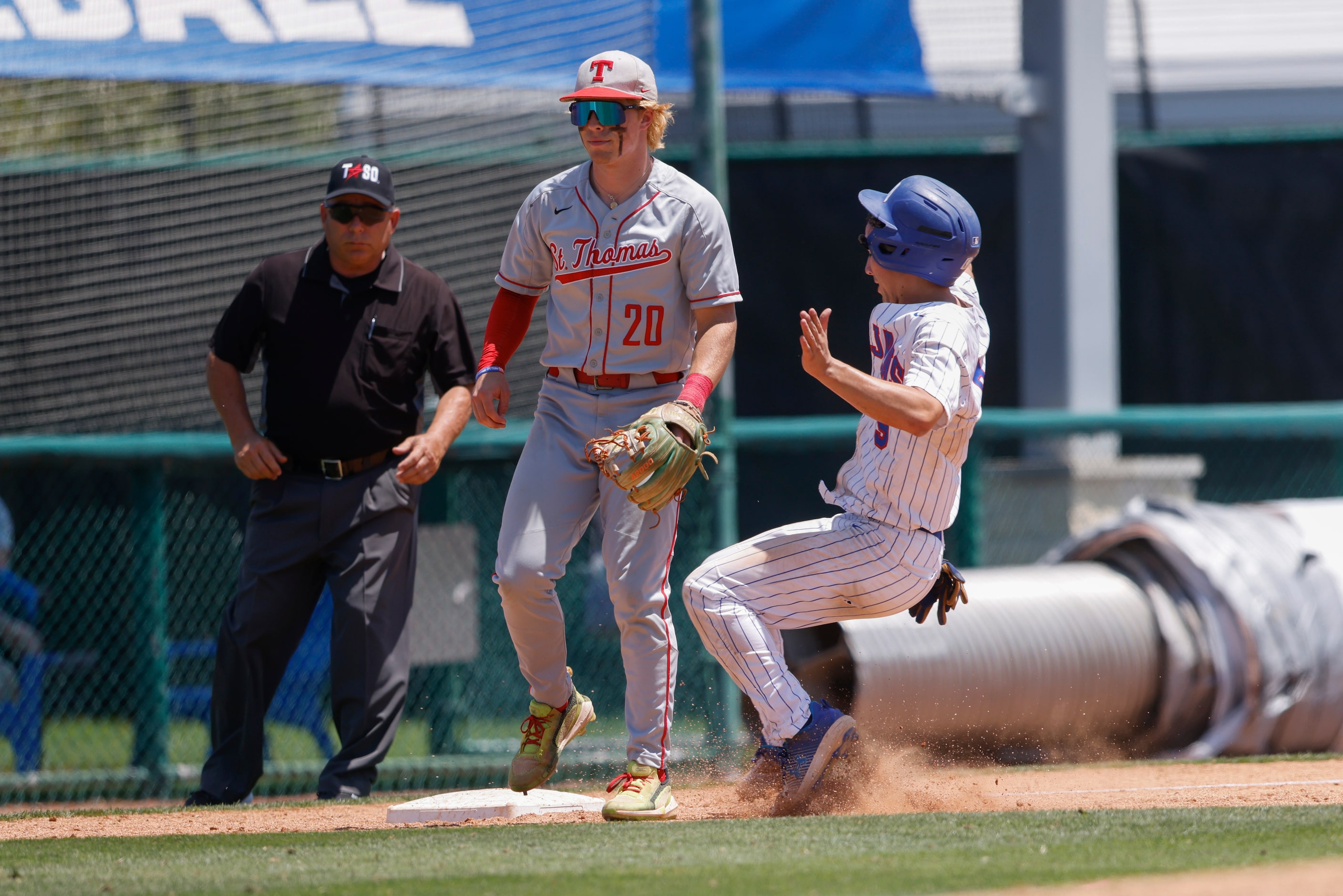 Trinity Christian player Joshua Liu (9) steals third base against Houston St. Thomas’ Billy...