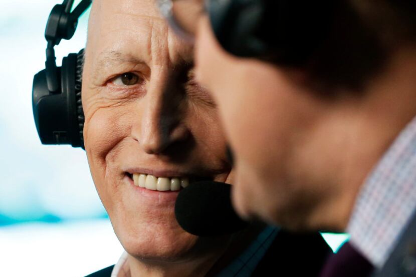 Dallas Stars play-by-play Dave Strader listens to broadcast partner Daryl "Razor" Reaugh...