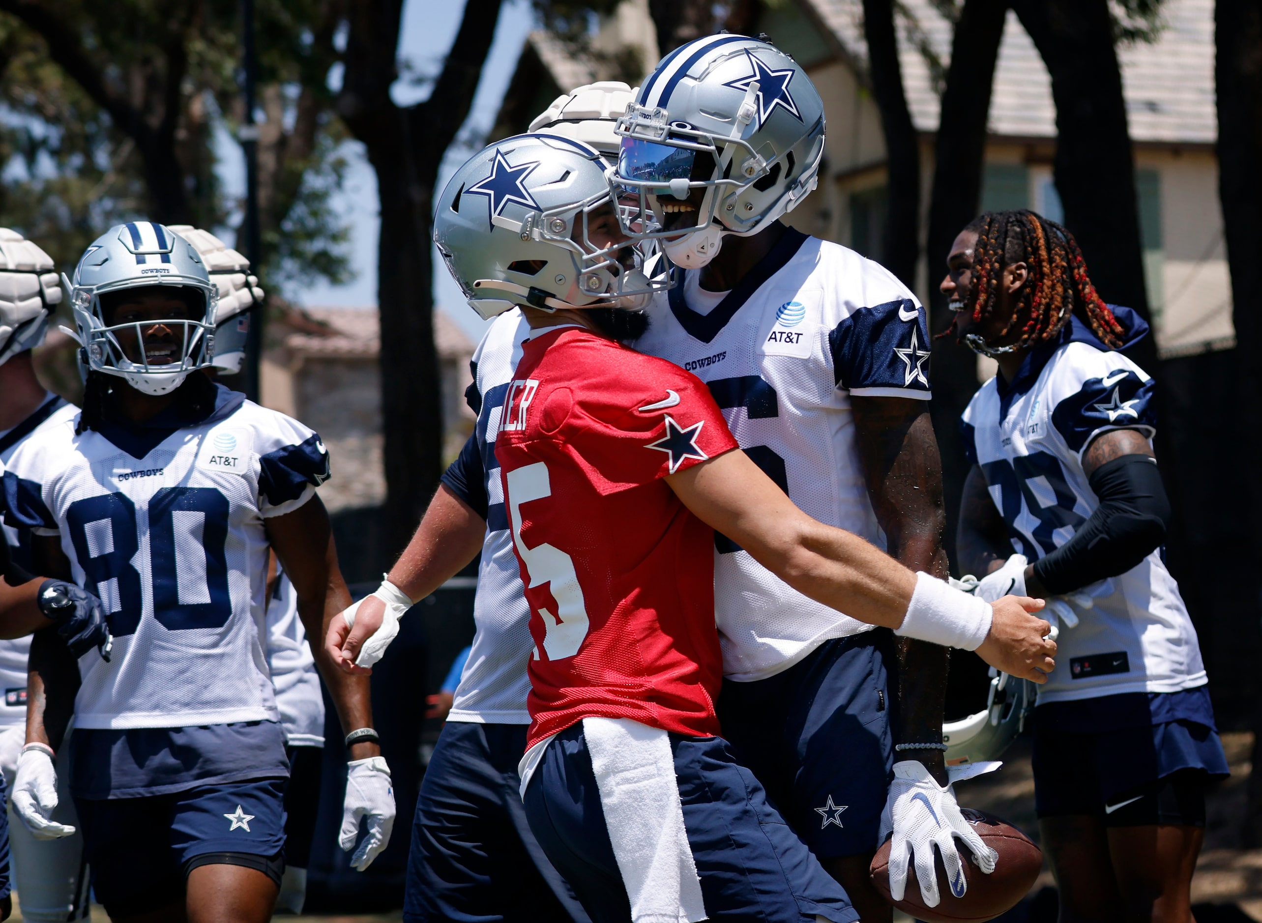 Dallas Cowboys wide receiver T.J. Vasher (16) is congratulated by quarterback Will Grier...