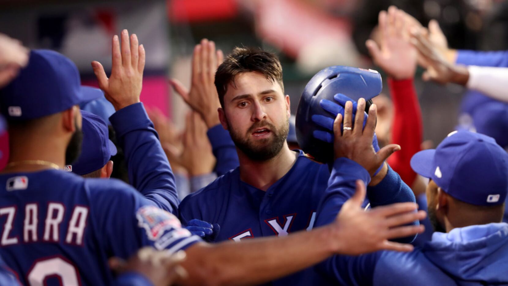 ANAHEIM, CALIFORNIA - APRIL 04:  Joey Gallo #13 of the Texas Rangers is congratulated in the...