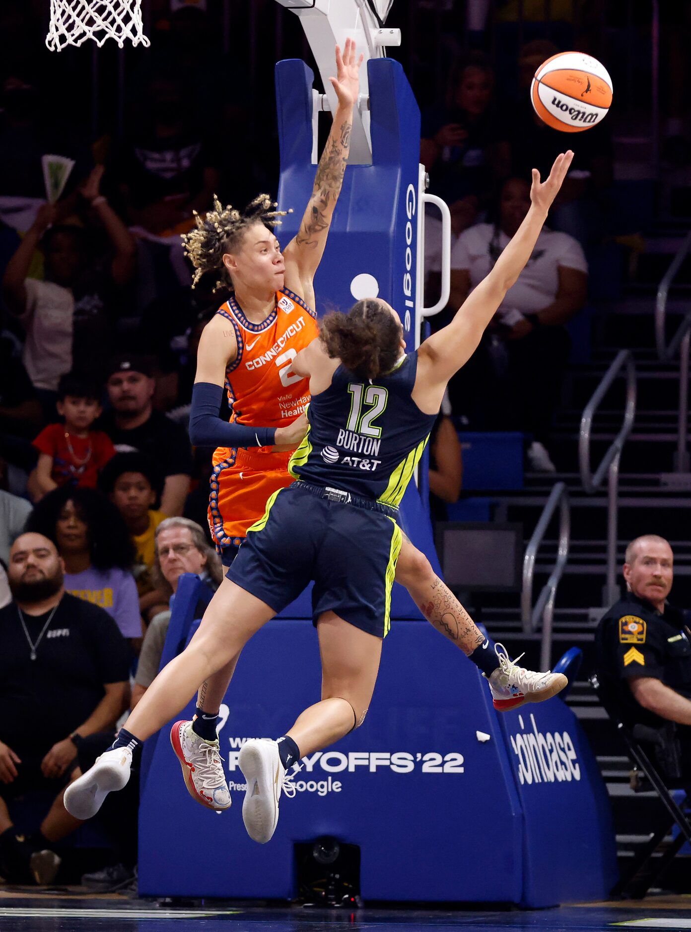 Dallas Wings guard Veronica Burton (12) puts up an off-balance shot over Connecticut Sun...