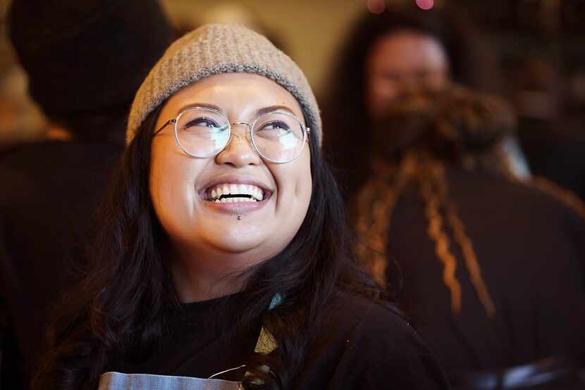 Chef Sarah Ranola laughs while working at a pop-up location of Hella Lumpia.