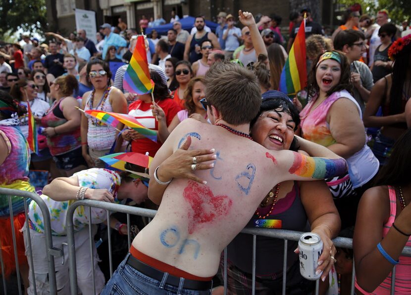 Diana Estrada of Plano receives a free hug from a Alan Ross Texas Freedom Parade participant...