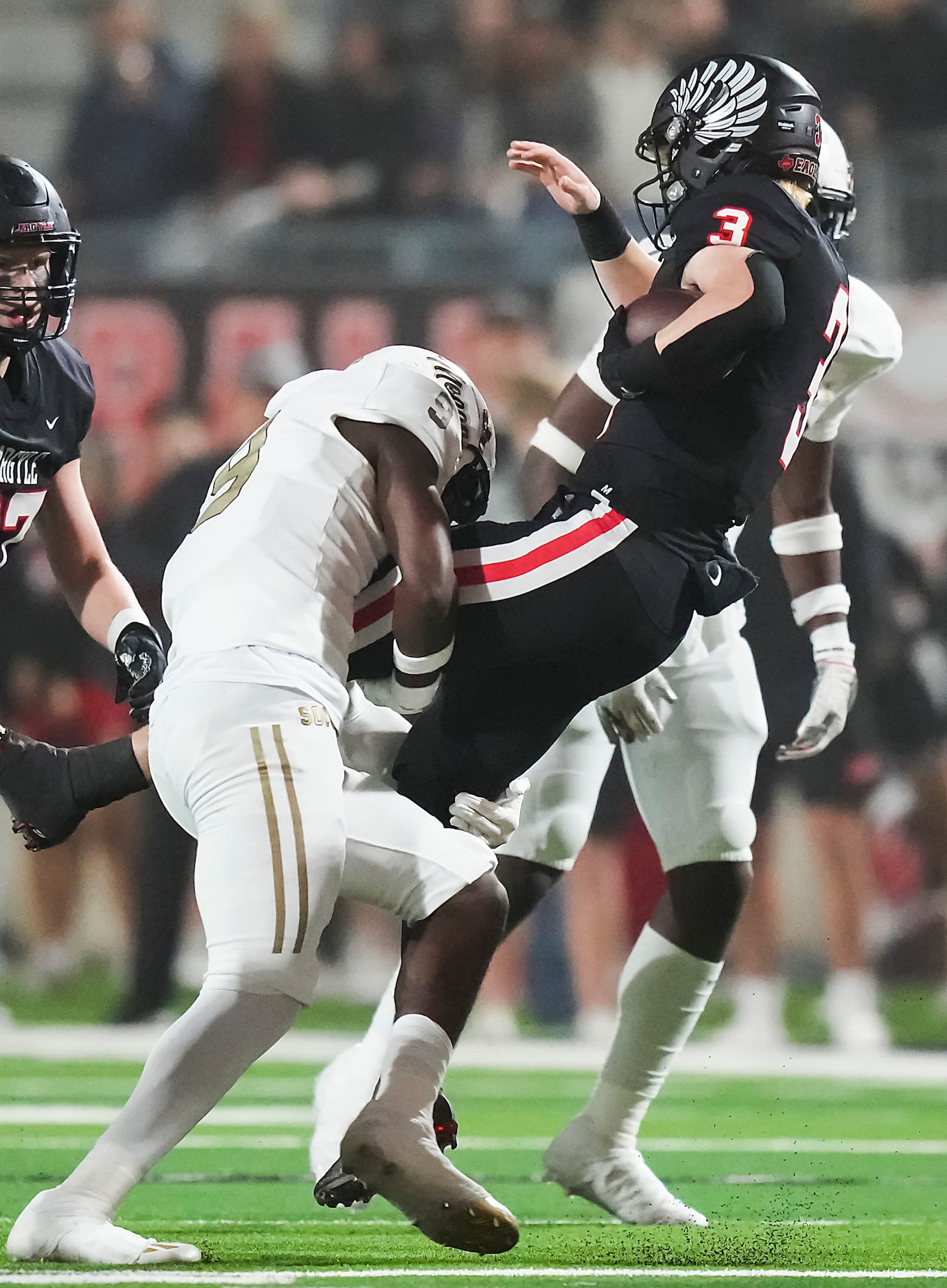 Argyle’s Jacob Robinson (3) is brought down by South Oak Cliff’s Dylan Brown-Turner (9)...