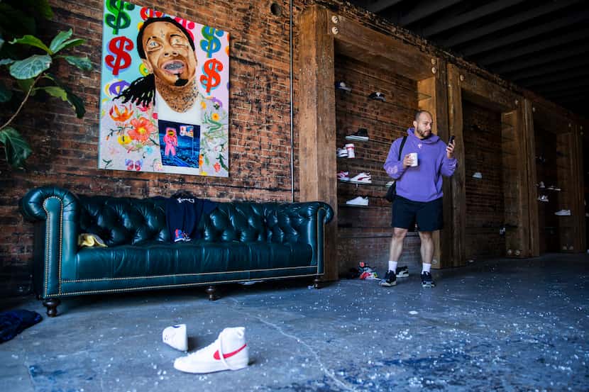 Sneaker Politics manager Kellen Daniel videos the damage done to the shop after it was...