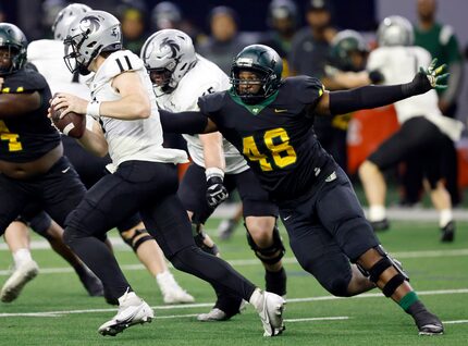 DeSoto defensive lineman Jason Douglas (48) sacked Denton Guyer quarterback Jackson Arnold...