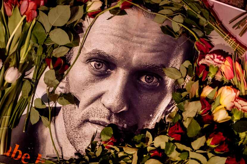 Flowers and a photo of Russian opposition leader Alexei Navalny are placed near the Russian...