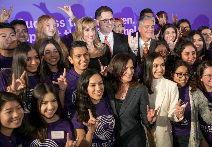 Michael and Susan Dell and UT President Gregory L. Fenves, right, gather for a photos with...