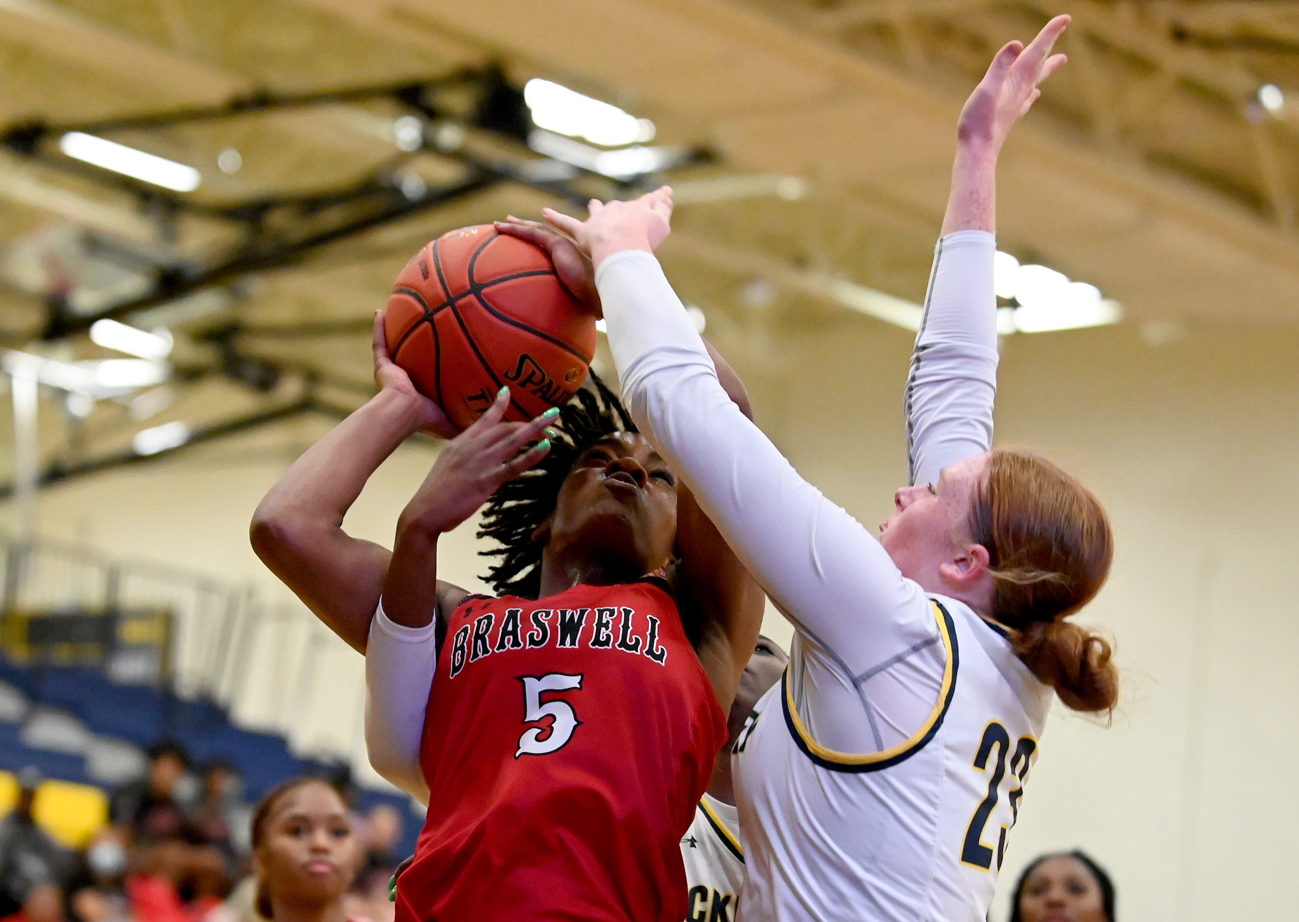 Braswell’s Danae Crosby (5) tries to shoot on McKinney’s Kylar Anamekwe (25) and Sam Tillson...