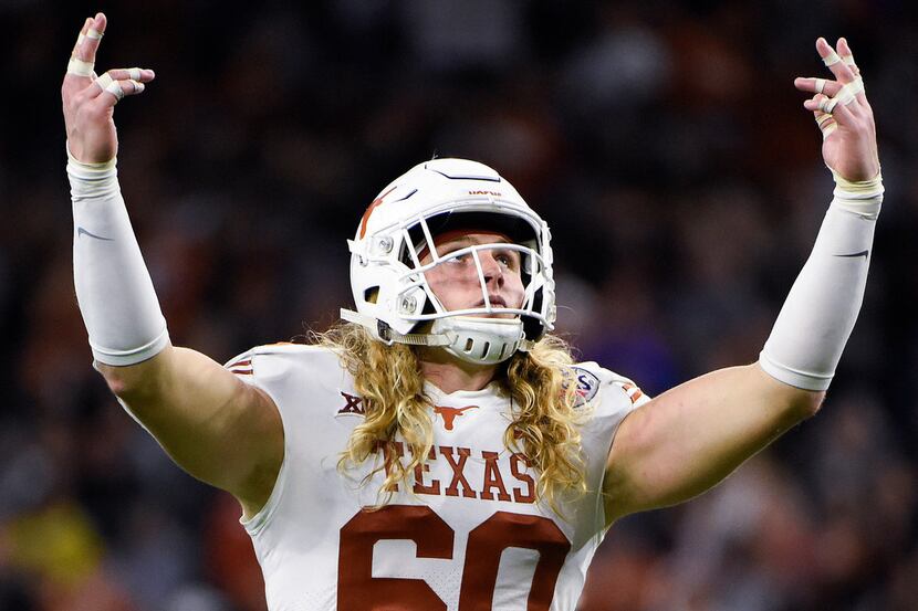 FILE - Texas linebacker Breckyn Hager gestures to the crowd before a third-down play during...