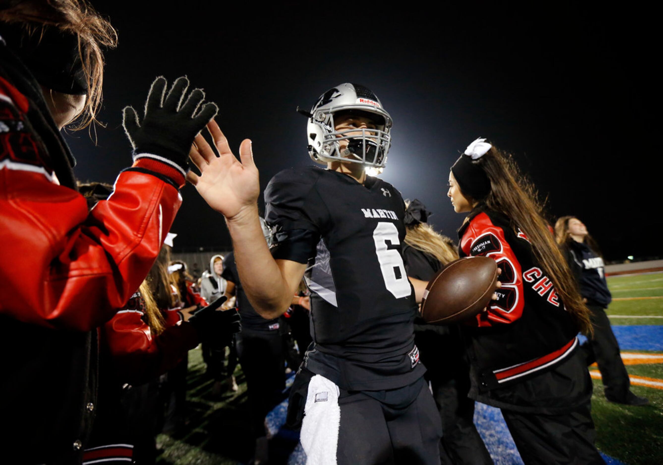 Martin quarterback Zach Mundell (6) is congratulated by cheerleaders after their District...