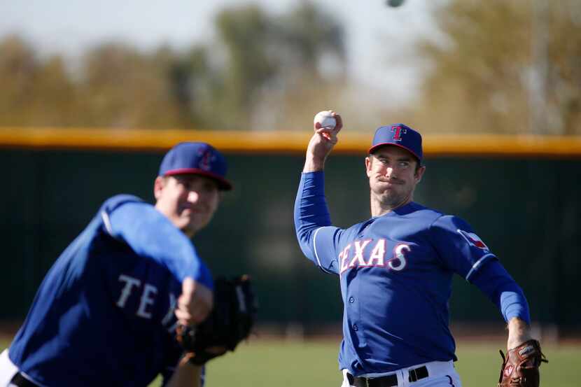 Texas Rangers pitcher Ross Ohlendorf throws during a workout at the Rangers spring training...