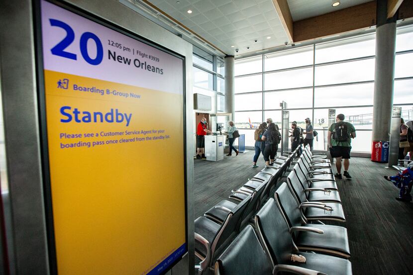 Passengers board a flight to New Orleans at Dallas Love Field in Dallas, Wednesday, May 19,...
