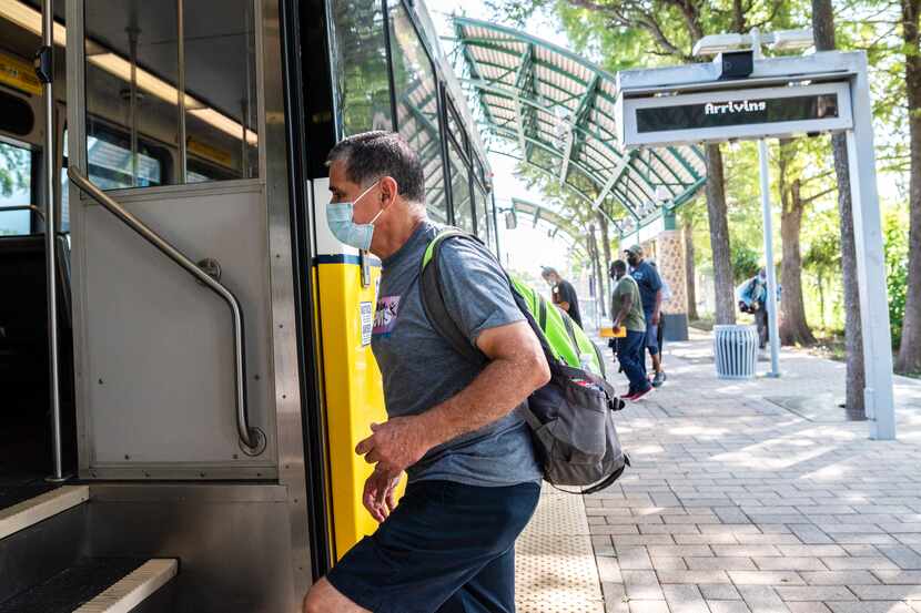Cheno Zubiri, who is fully vaccinated, wears a mask as he enters a DART train at the Dallas...