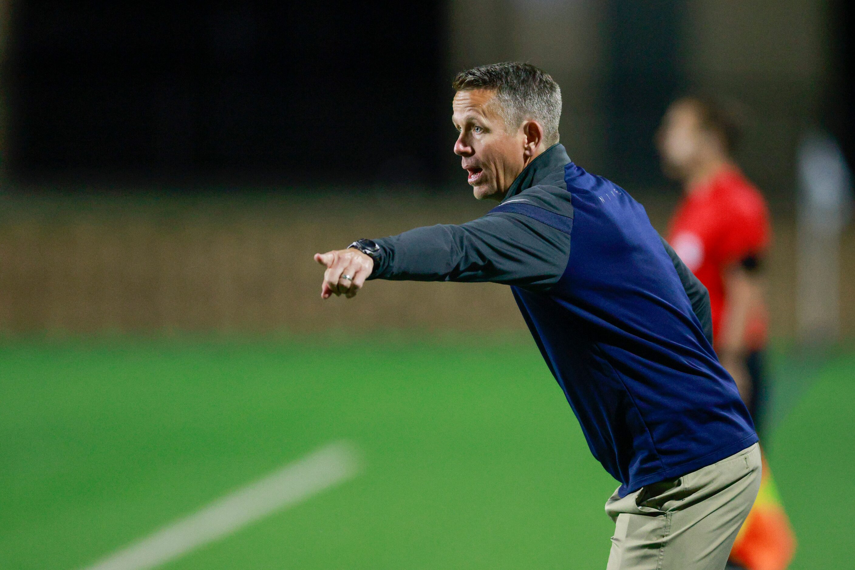 Frisco Wakeland head coach Andy Holt talks to his team during the second half of a Class 5A...