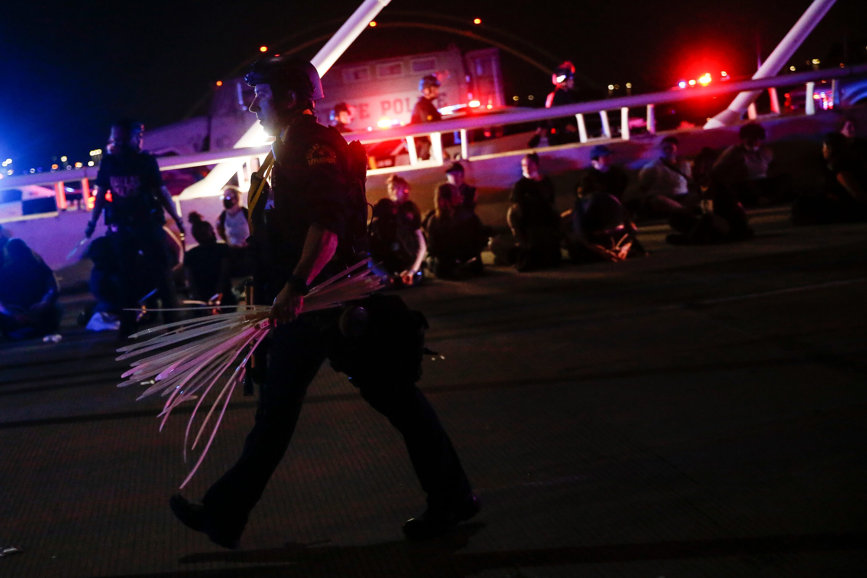 Police surround and detain hundreds of protesters who marched onto the Margaret Hunt Hill...