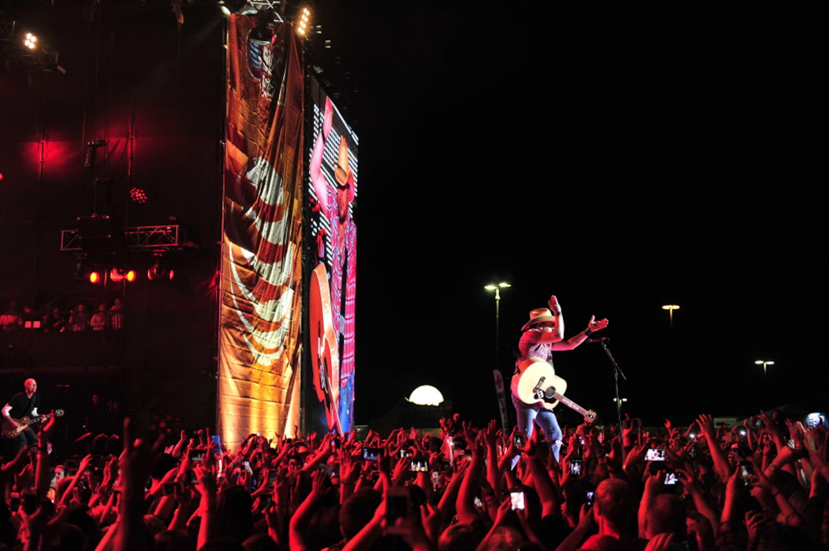 Jason Aldean performs onstage at the 2014 NCAA March Madness Music Festival during the NCAA...