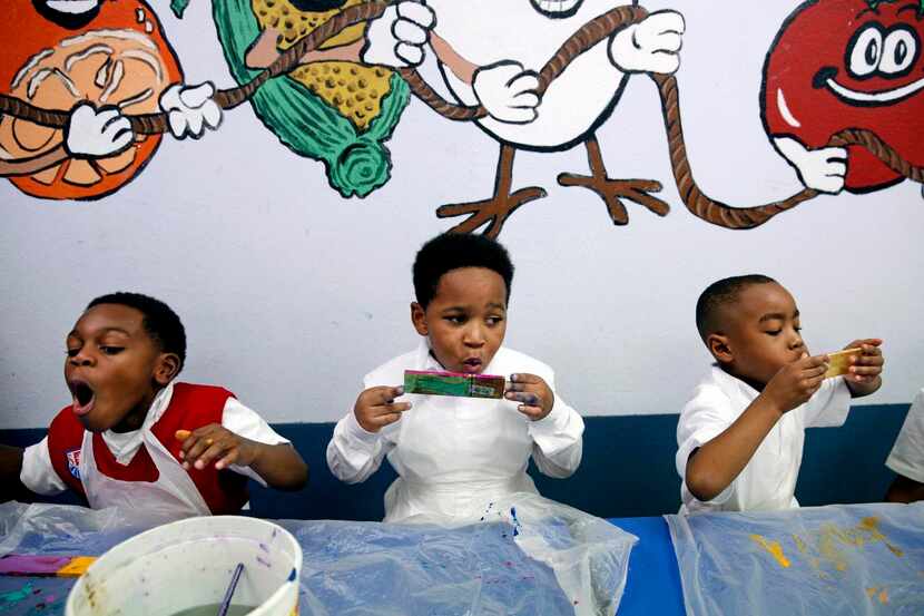 
Kindergartners Jaxon McKinney (left) and Preston Chapelle and prekindergartner Lyles Lewis...