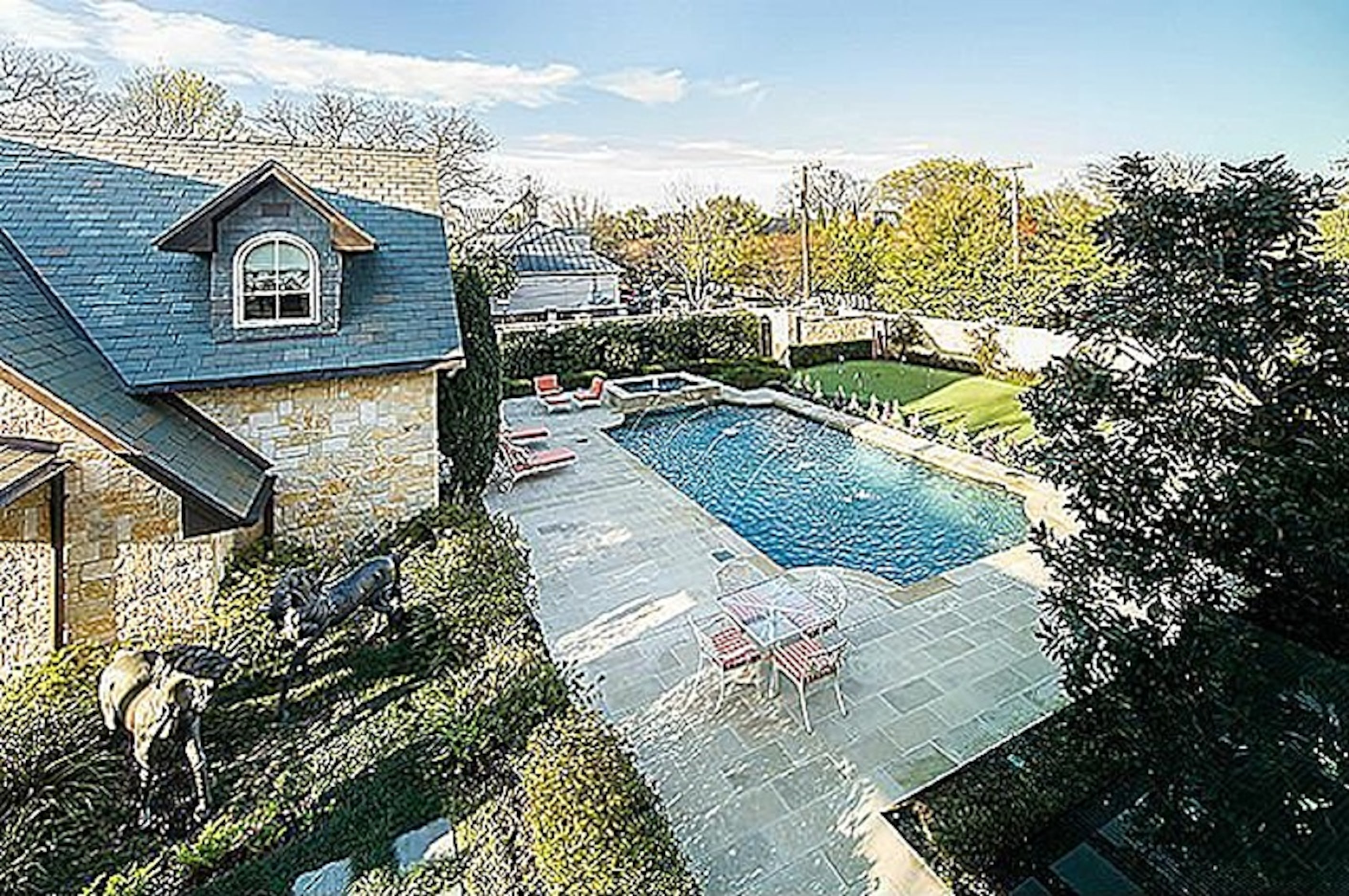 A side view of the home's lap pool which also includes a putting green. 